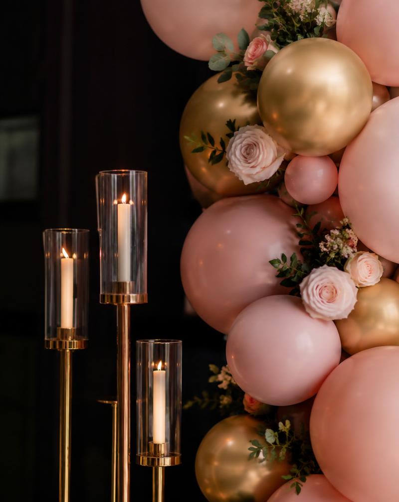 Pink and gold balloon décor with candles